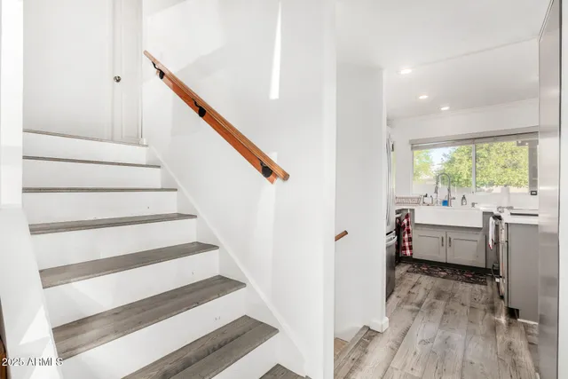 a view of entryway and hall with wooden floor
