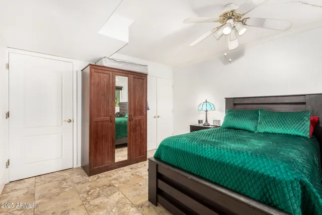 a bedroom with a bed and a chandelier