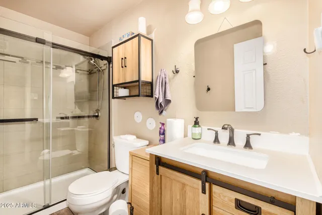 a bathroom with a sink toilet and shower