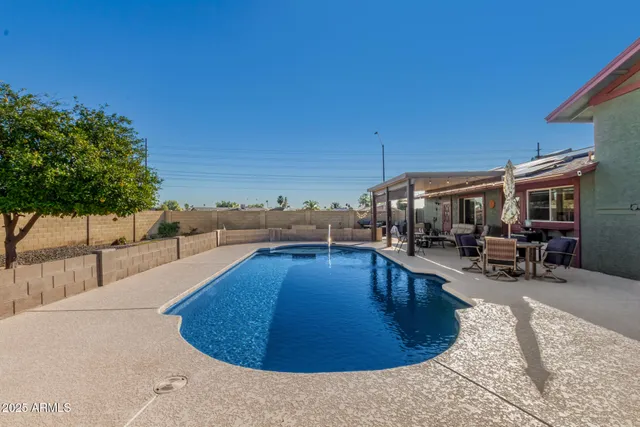 a view of a swimming pool with sitting area