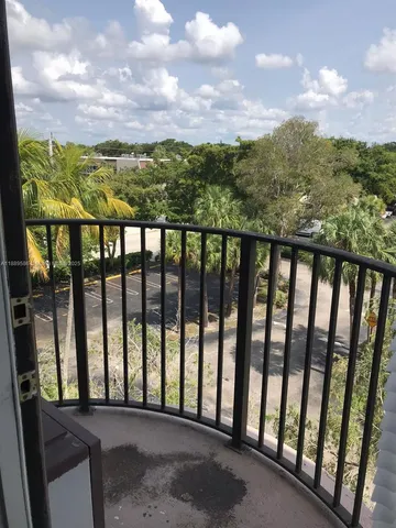 an empty room with wooden floor and a bathroom