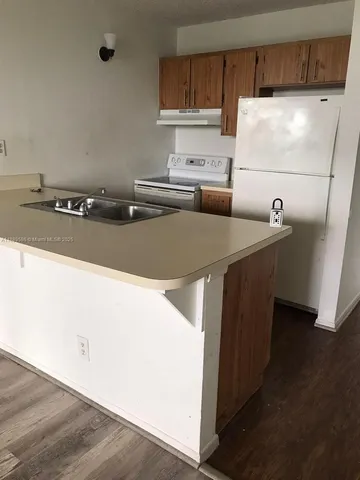 a kitchen with stainless steel appliances a sink and a refrigerator
