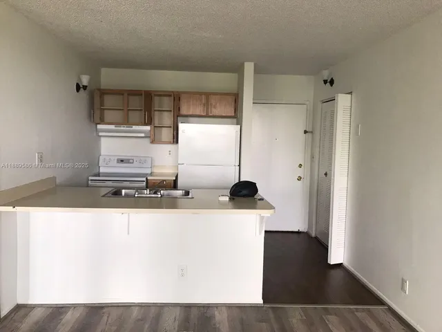 a kitchen with stainless steel appliances a refrigerator and a stove