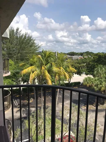 an empty room with wooden floor and entrance