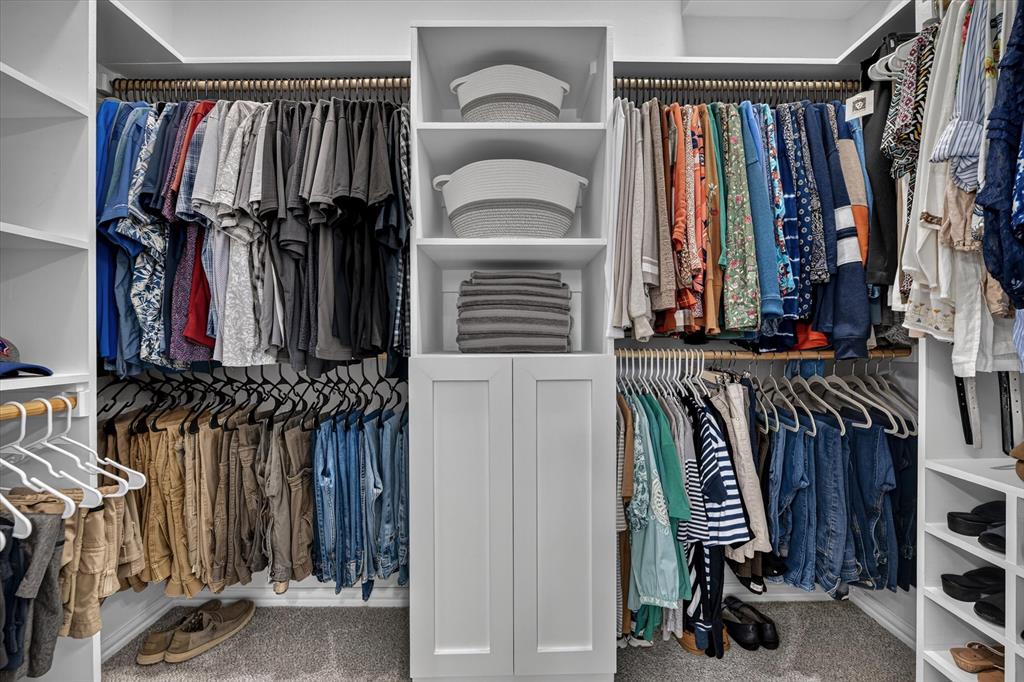 421 Ben Boyd Road Argyle, TX 76226 - Photo 11 of 25 Custom closet system featuring white built-in cabinetry, open shelving, and multiple hanging rods