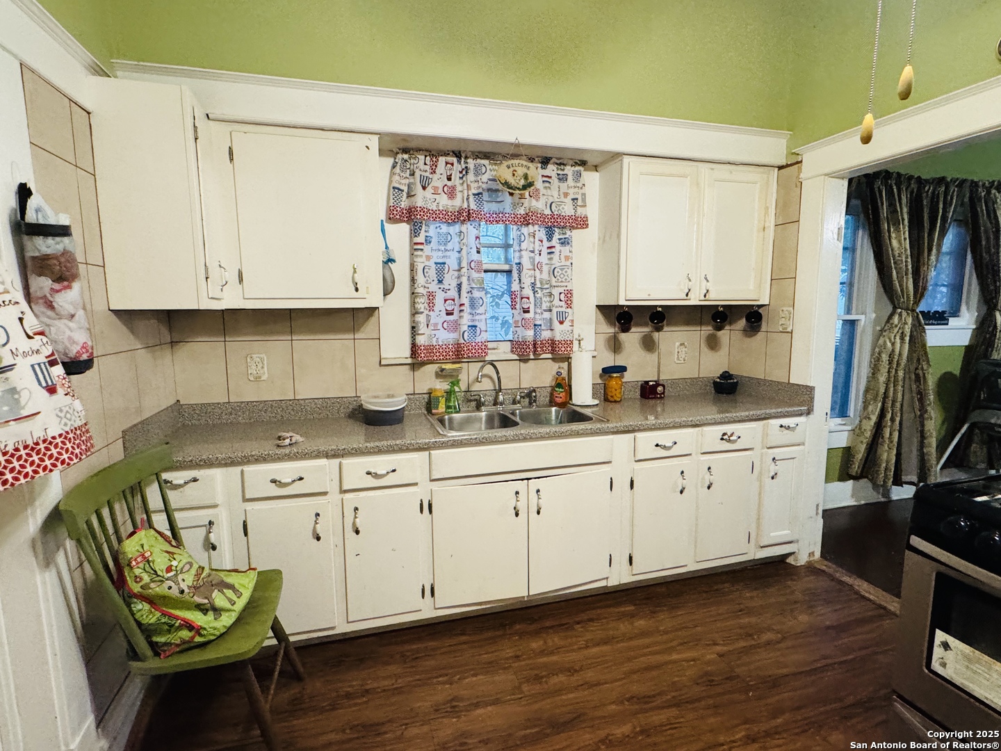 314 Devine Street San Antonio, TX 78210 - Photo 12 of 25 a kitchen with granite countertop a sink cabinets and wooden floor