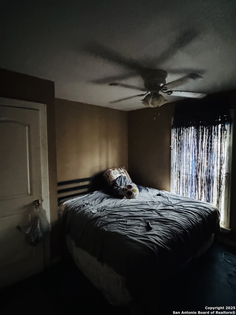 314 Devine Street San Antonio, TX 78210 - Photo 24 of 25 a bed sitting in a bedroom next to a window
