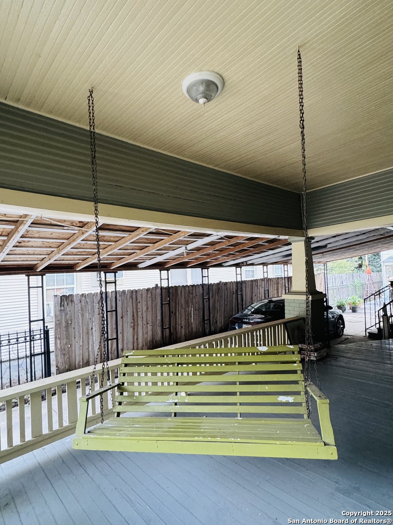 314 Devine Street San Antonio, TX 78210 - Photo 5 of 25 a room with a bed and a chandelier