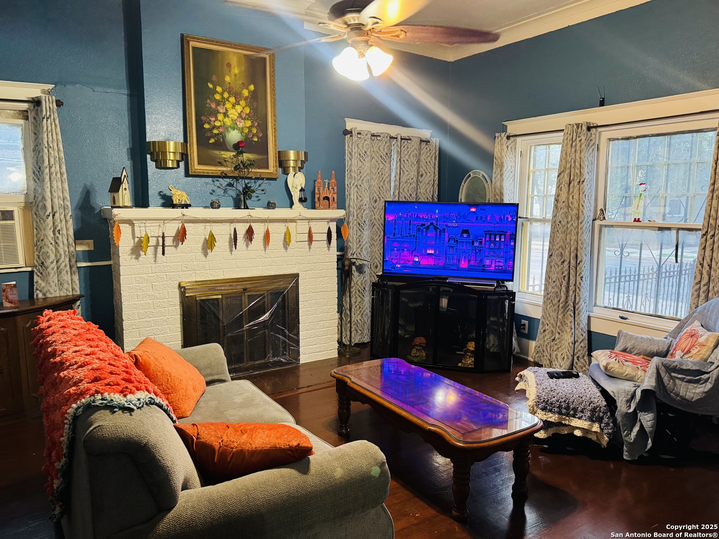 314 Devine Street San Antonio, TX 78210 - Photo 7 of 25 a living room with furniture a flat screen tv and a fireplace