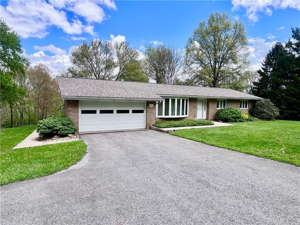 143 Schnur Road Butler, PA 16002 - Photo 18 of 50 a front view of a house with a yard and garage