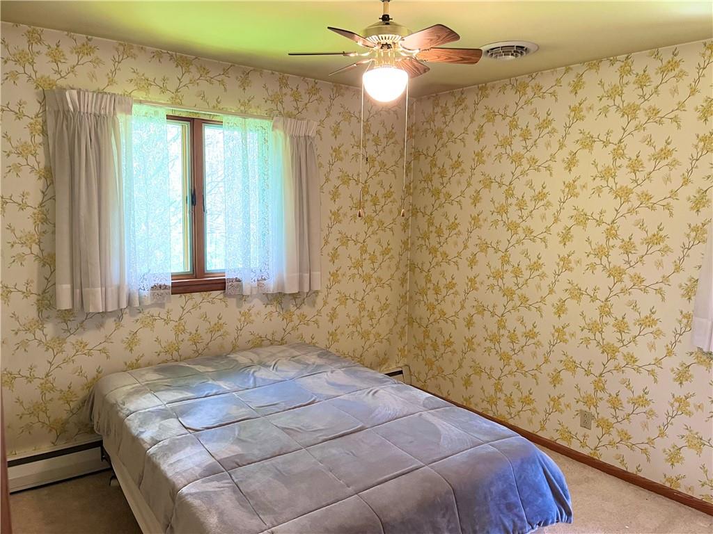 143 Schnur Road Butler, PA 16002 - Photo 40 of 50 a bedroom with a bed and a chandelier