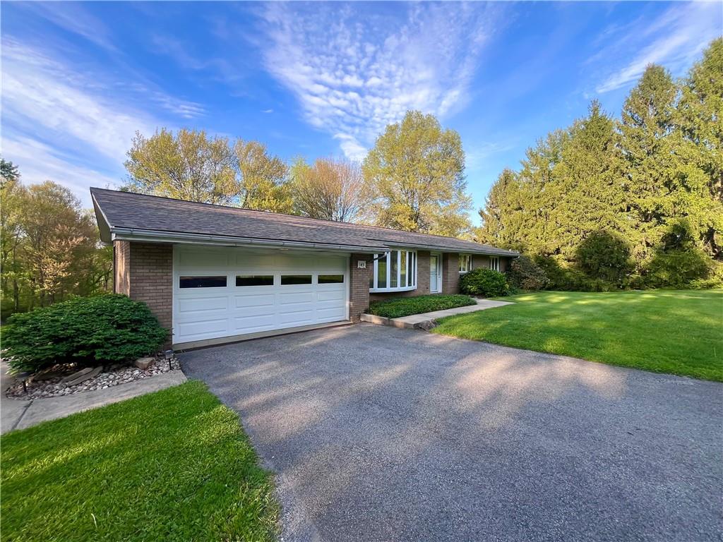 143 Schnur Road Butler, PA 16002 - Photo 4 of 50 a front view of a house with a garden and yard