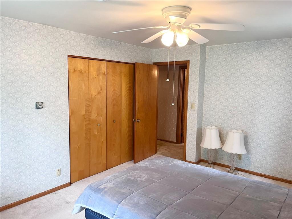 143 Schnur Road Butler, PA 16002 - Photo 47 of 50 a view of a hallway with a chandelier fan and a bathroom