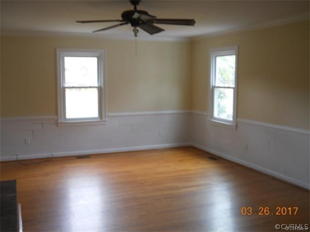 15519 Baltimore Road Dewitt, VA 23840 - Photo 7 of 13 an empty room with wooden floor and windows