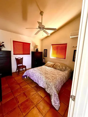 a living room with lots of furniture and large windows
