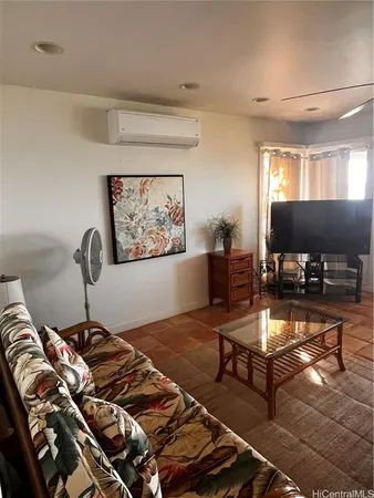 a bedroom with a bed and dresser with mirror