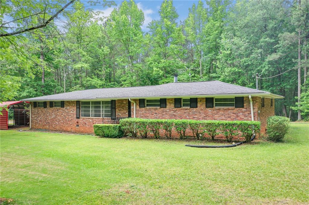 5232 North Helton Road Winston, GA 30187 - Photo 1 of 1 a front view of a house with garden