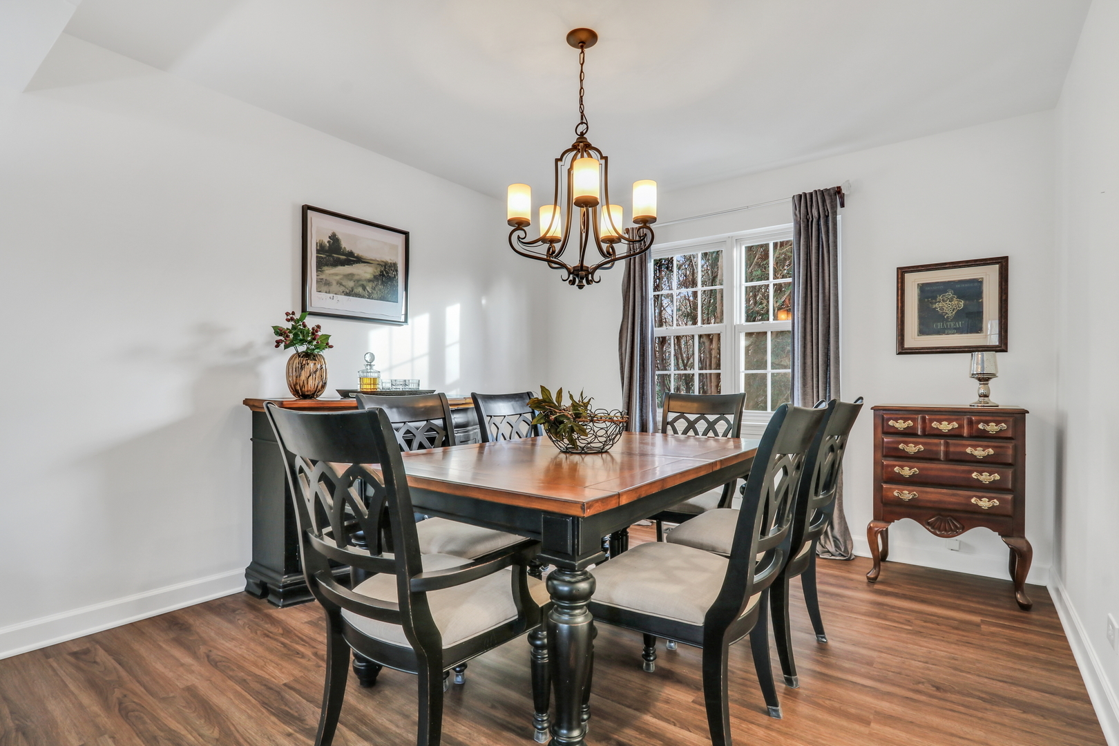 269 Braxton Way Grayslake, IL 60030 - Photo 7 of 38 a dining room with wooden floor a chandelier a wooden table and chairs
