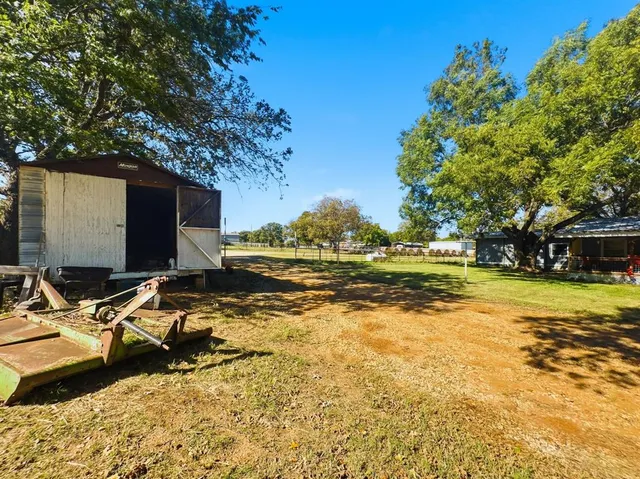 a living room with furniture a flat screen tv and a dining table with wooden floor