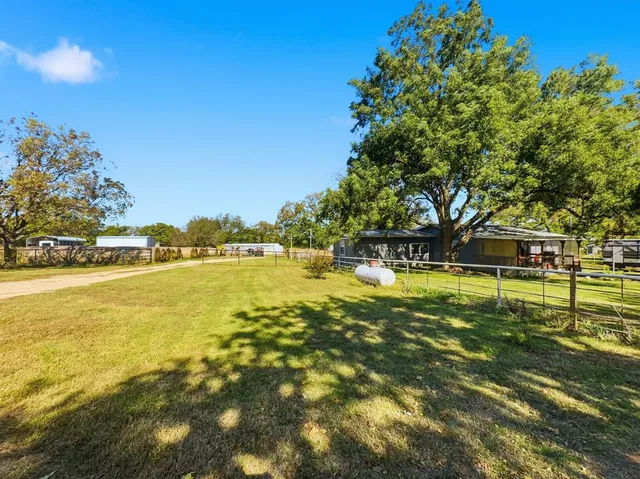 a bathroom with a sink mirror and shower