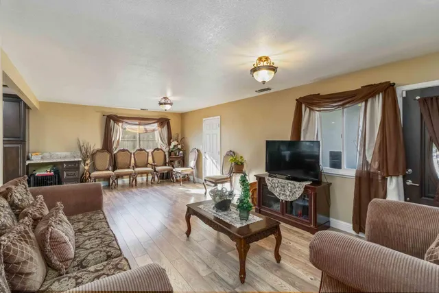 a kitchen with stainless steel appliances granite countertop a refrigerator a stove and a sink