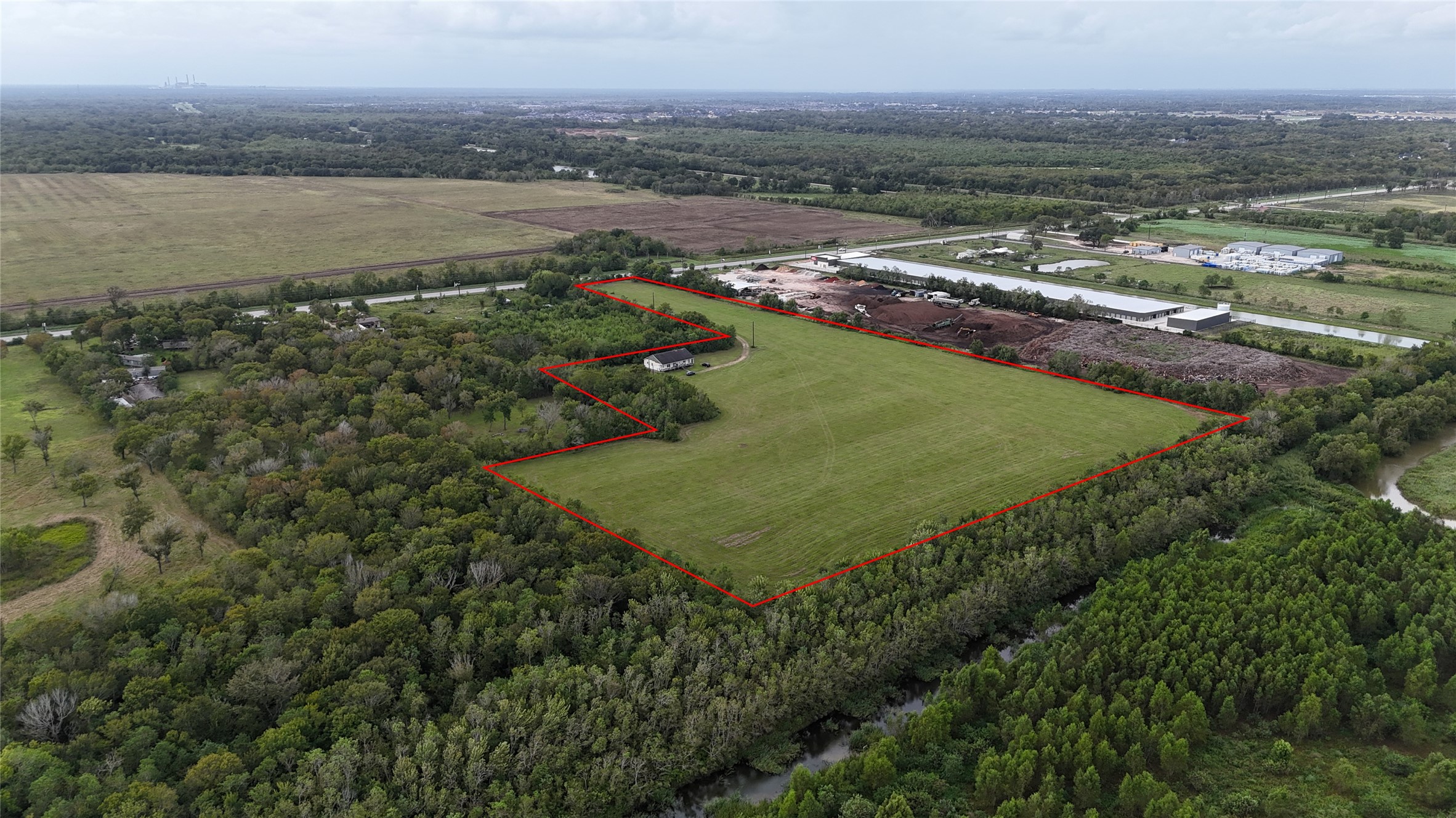 9621 FM 521 Road Rosharon, TX 77583 - Photo 1 of 14 This expansive 17.286-acre tract features mostly flat, cleared land with minimal tree coverage, offering a substantial open footprint for future development.