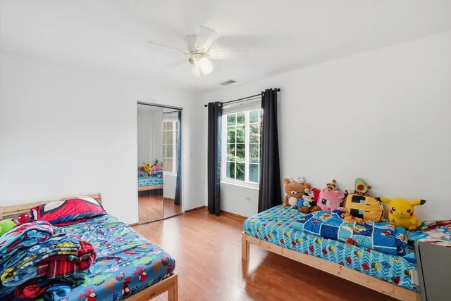 a bedroom with baby bed and a window