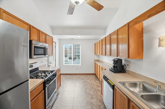 a kitchen that has a sink and a stove top oven
