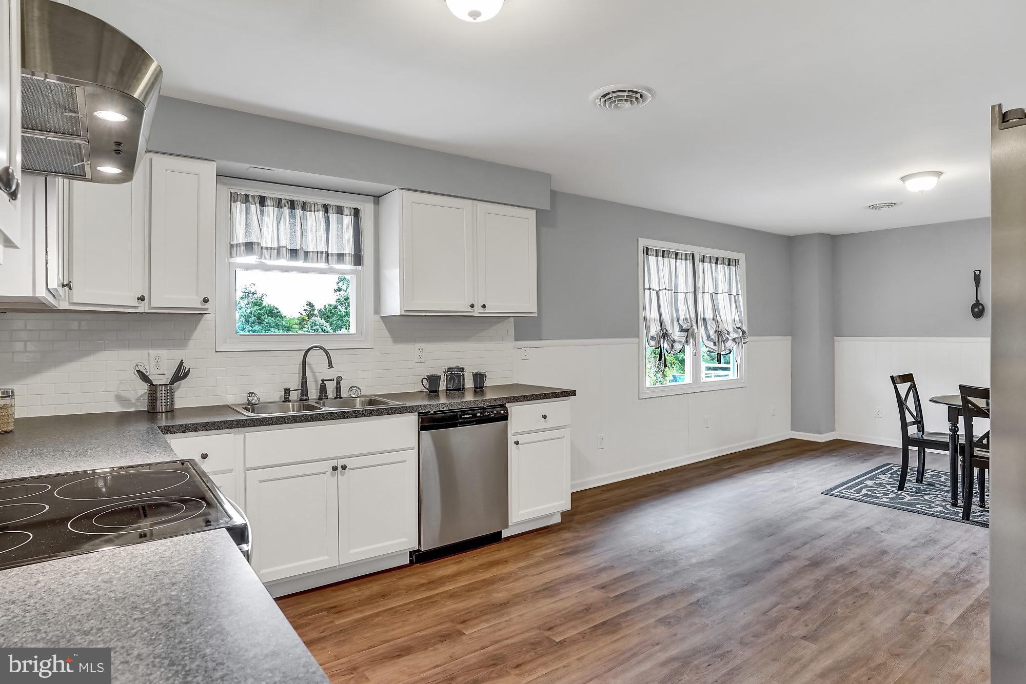 13296 Fishel Road Felton, PA 17322 - Photo 5 of 51 a kitchen with granite countertop a sink a window stainless steel appliances and cabinets
