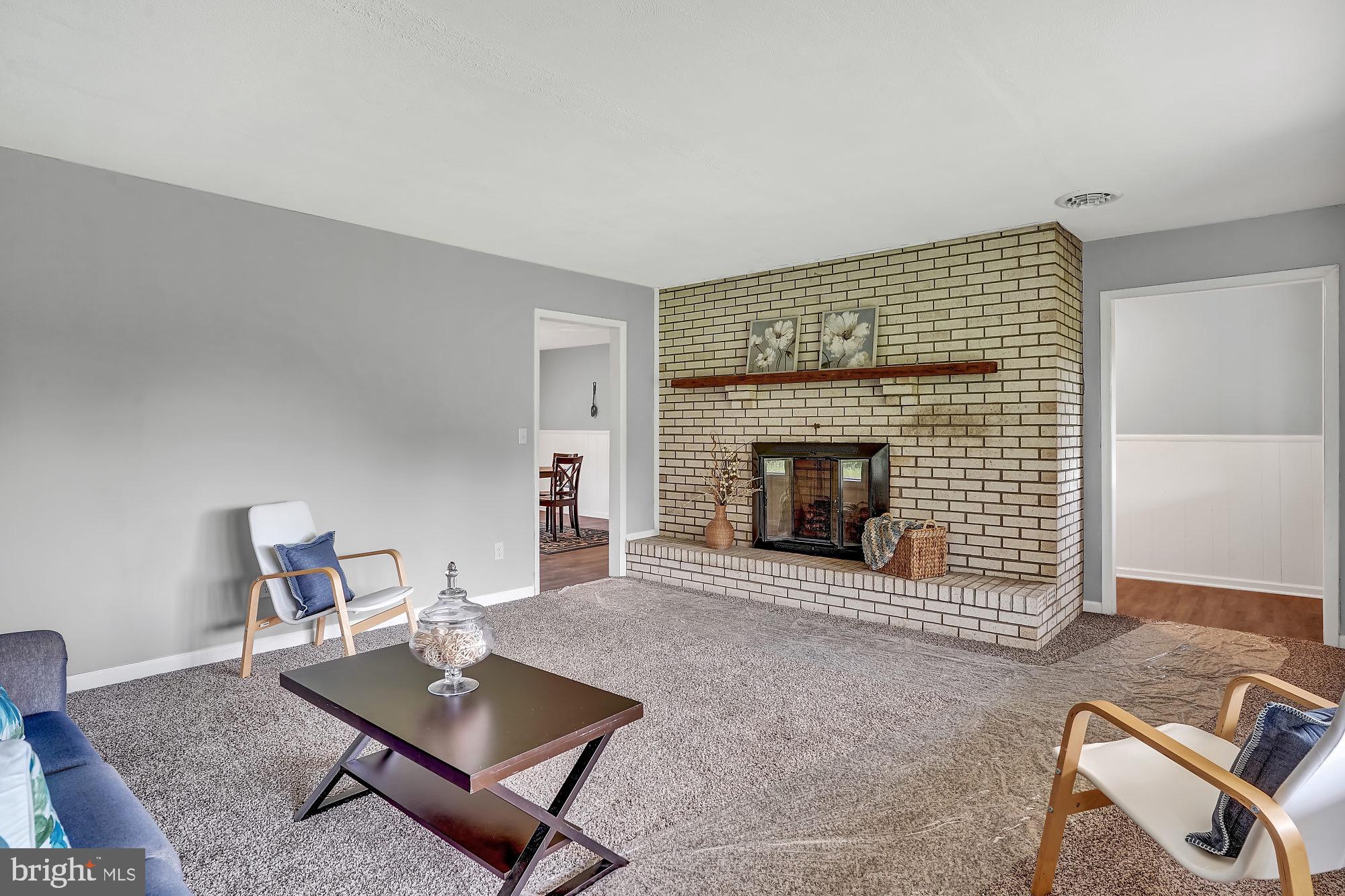 13296 Fishel Road Felton, PA 17322 - Photo 10 of 51 a living room with furniture a fireplace and a table