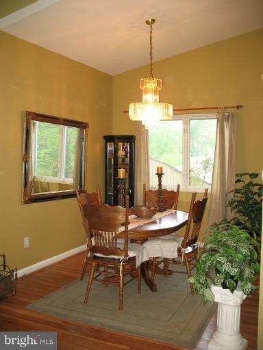 806 Malta Lane Silver Spring, MD 20901 - Photo 14 of 30 a dining room with furniture a chandelier and wooden floor