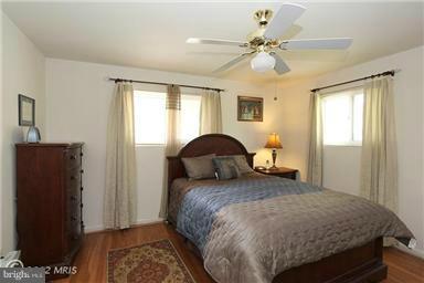 806 Malta Lane Silver Spring, MD 20901 - Photo 16 of 30 a bedroom with a bed and a chandelier