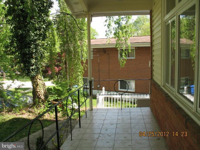 806 Malta Lane Silver Spring, MD 20901 - Photo 22 of 30 a balcony with chairs and with trees