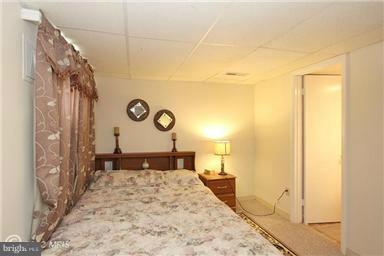 806 Malta Lane Silver Spring, MD 20901 - Photo 24 of 30 a bedroom with a bed and wooden floor