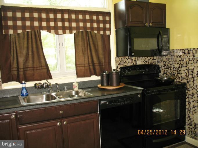 806 Malta Lane Silver Spring, MD 20901 - Photo 28 of 30 a kitchen with a sink and a microwave