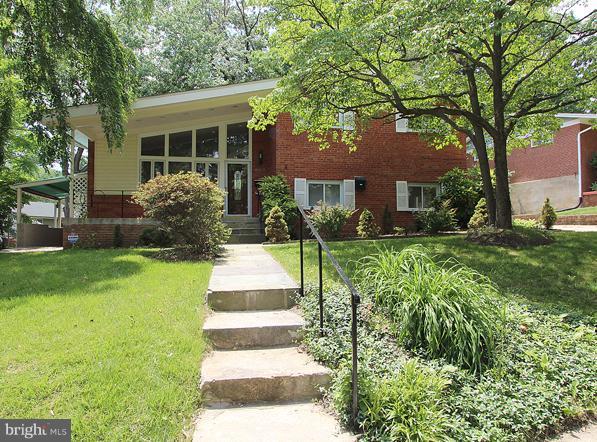 806 Malta Lane Silver Spring, MD 20901 - Photo 30 of 30 a front view of a house with a yard and fountain in middle