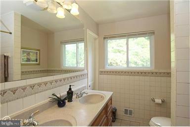 806 Malta Lane Silver Spring, MD 20901 - Photo 5 of 30 a bathroom with a sink mirror toilet and next to a window