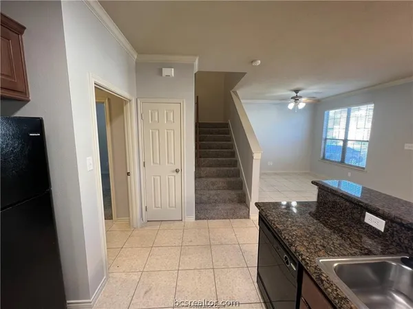 a kitchen with granite countertop a sink and a stove