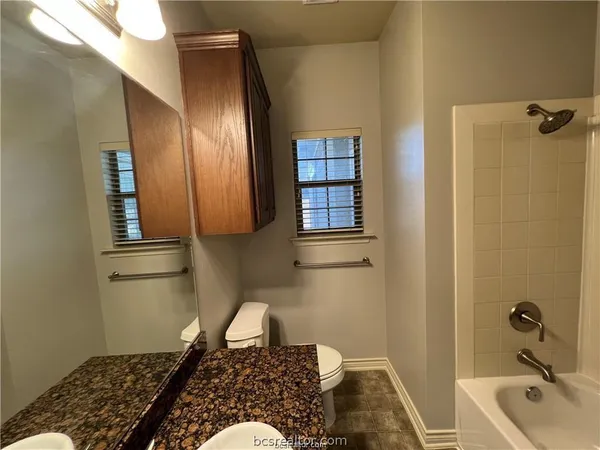 a bathroom with a bathtub and shower