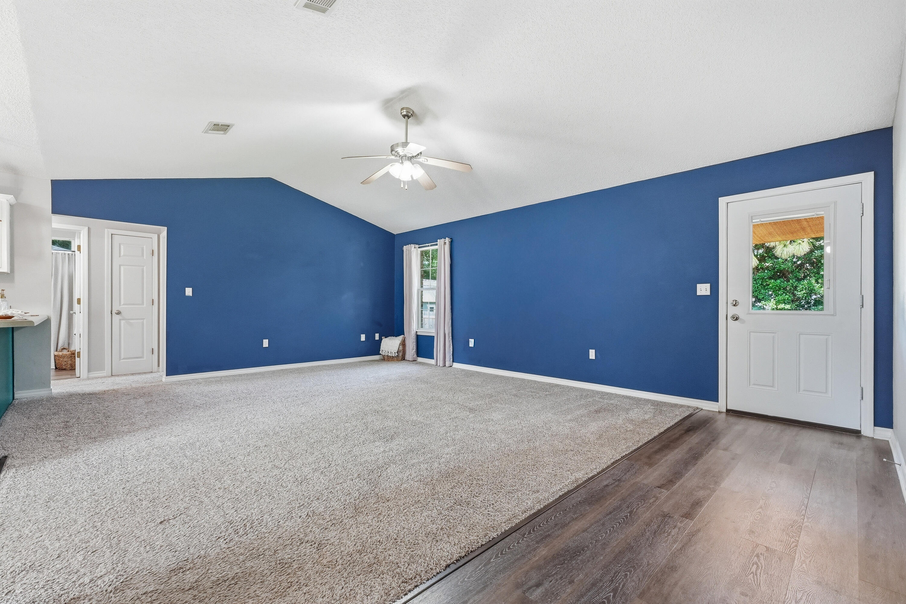 3033 Cabela Lane Crestview, FL 32539 - Photo 3 of 32 a view of an empty room with window and wooden floor