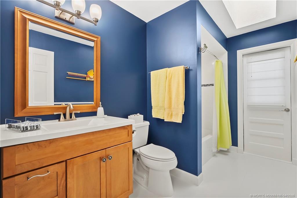 4620 Southeast Quail Trail Stuart, FL 34997 - Photo 22 of 71 a bathroom with a sink vanity and a mirror