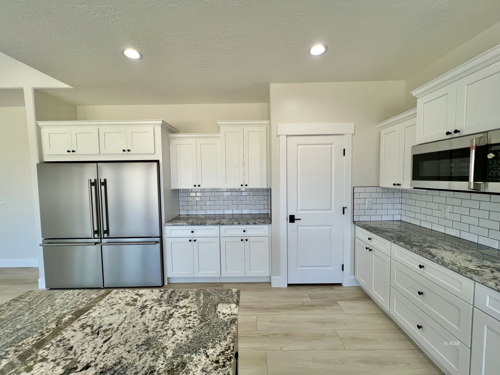 1597 Sun Vly Road, Unit C7 Spring Creek, NV 89815 - Photo 11 of 43 a kitchen with granite countertop a refrigerator and a sink