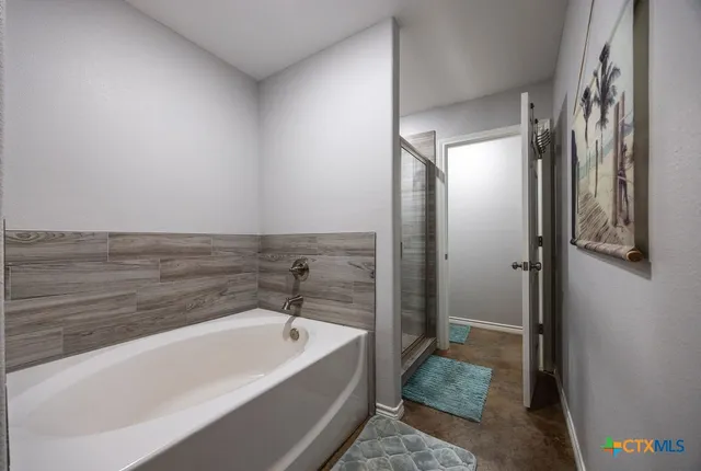 a bathroom with a bathtub and shower