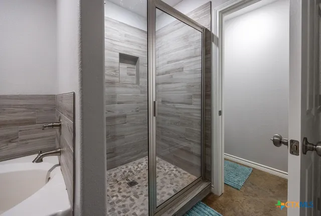 a bathroom with a glass shower door