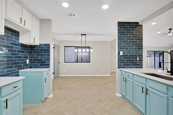 a kitchen with a sink and cabinets