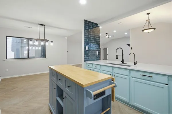a spacious bathroom with a sink a large mirror and vanity