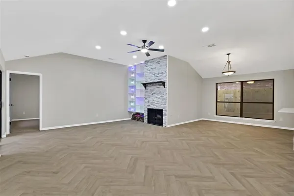 a view of an empty room with a fireplace