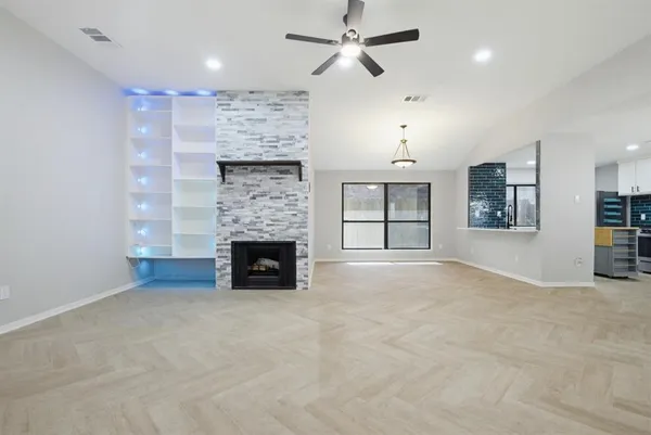 an empty room with furniture and a fireplace