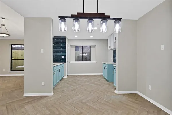 a kitchen with stainless steel appliances a stove a sink a microwave a refrigerator and cabinets