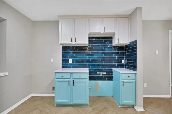 a kitchen with a sink and cabinets